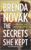 Book cover for "The secrets she kept".